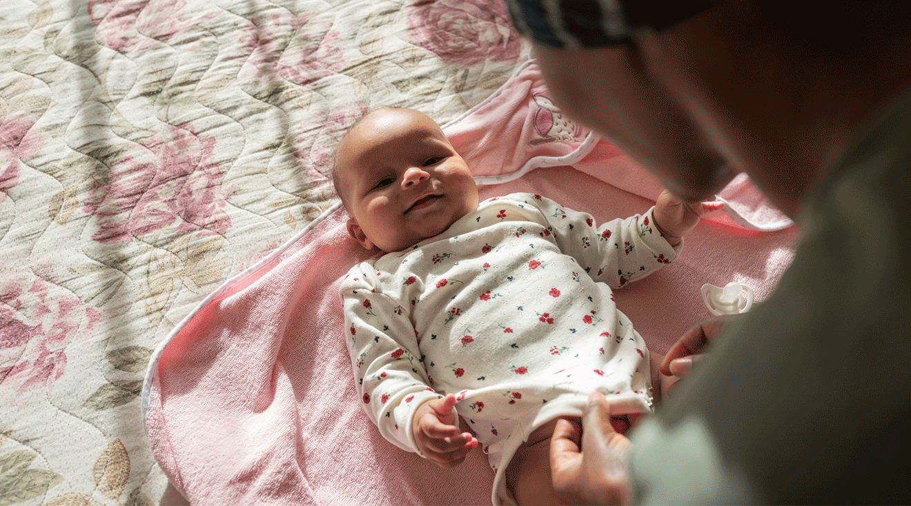 mom looking at smiling baby