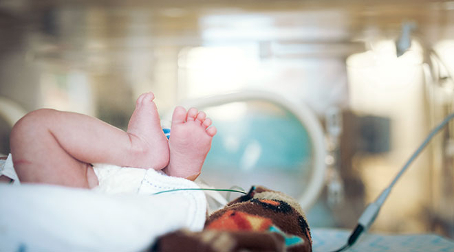 premature baby feet in nicu at hospital