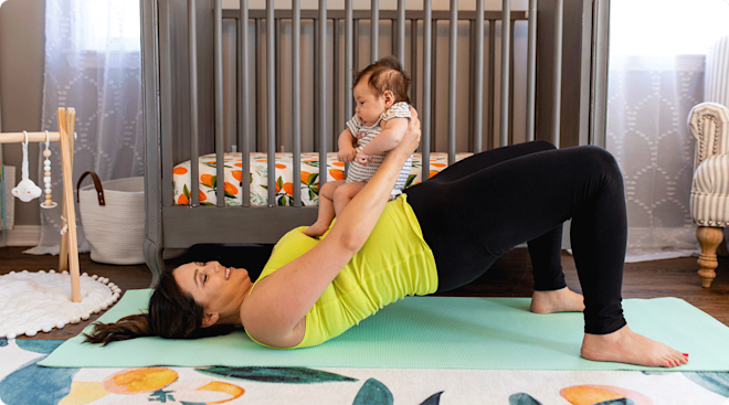 postpartum mom doing yoga with baby at home in nursery