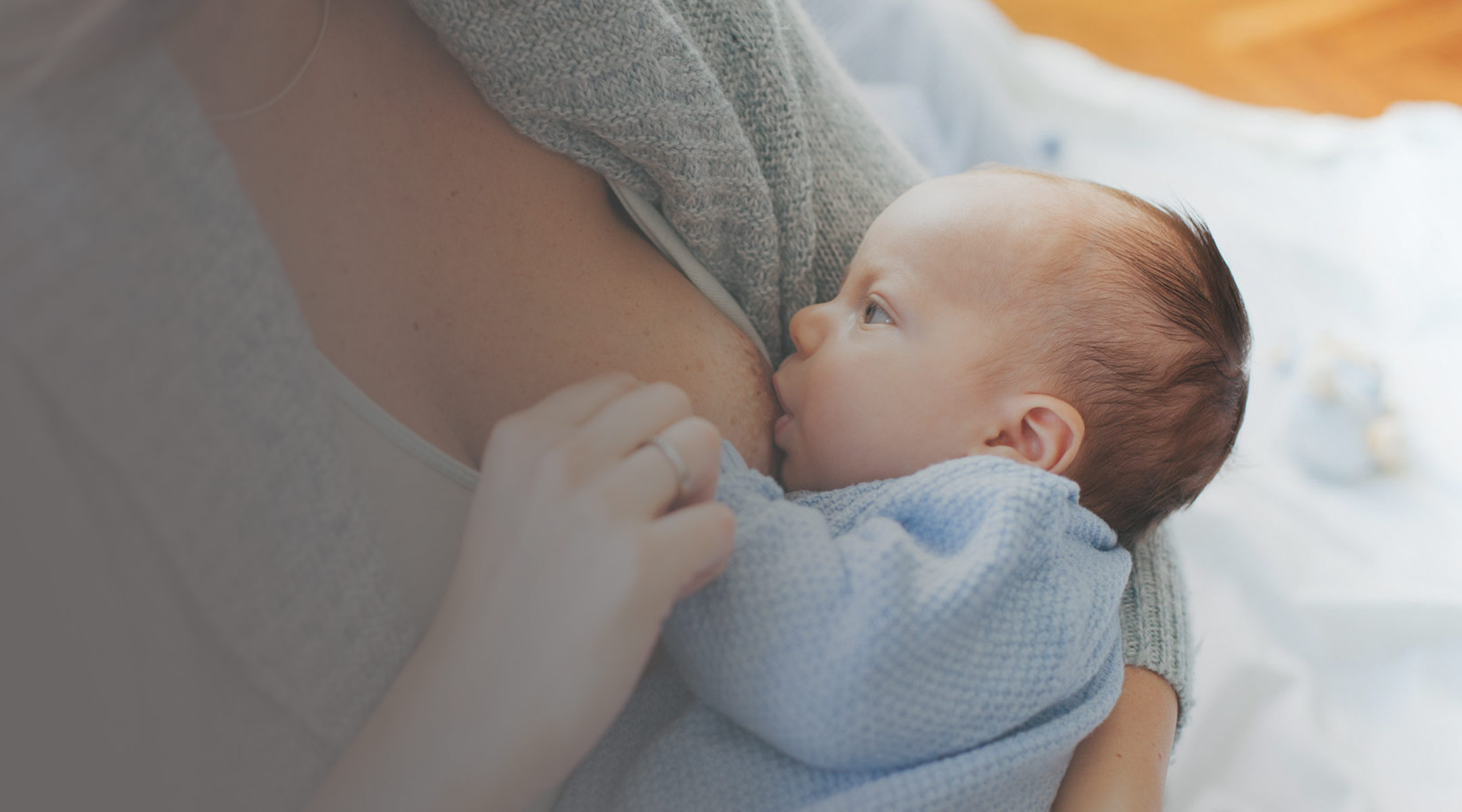 woman breastfeeding her newborn baby