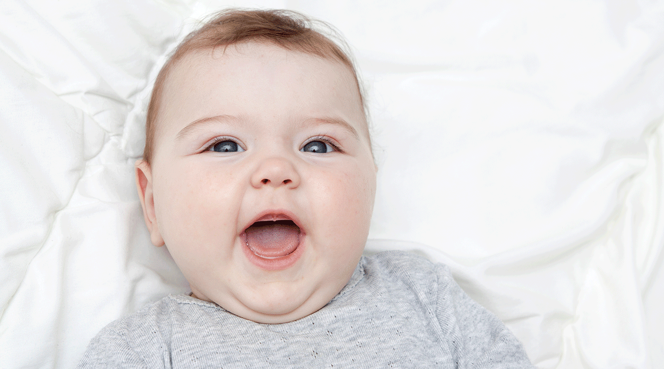 smiling baby showing tongue