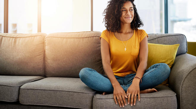woman smiling and sitting on couch
