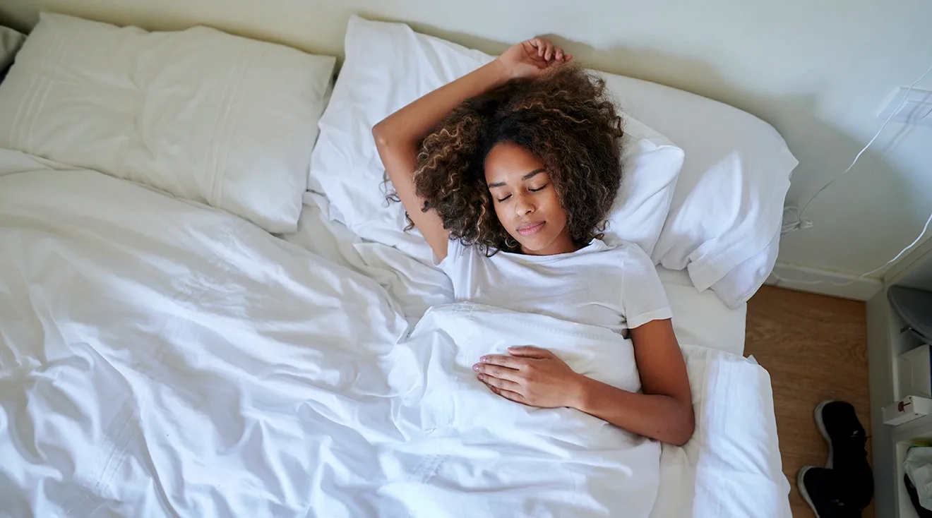 tired woman lying down in bed