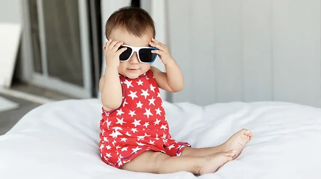 baby wearing sunglasses and patriotic outfit for memorial day