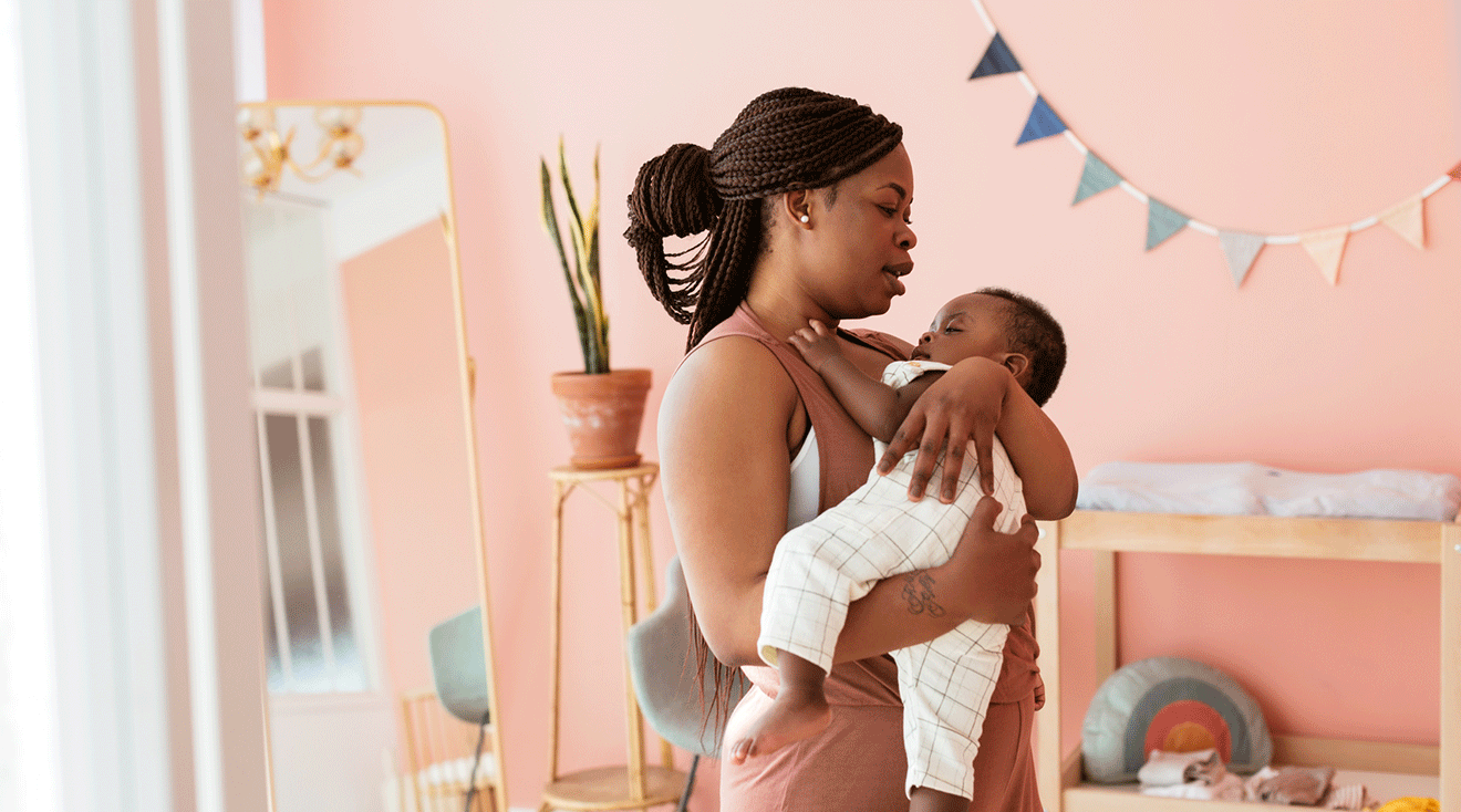 mom singing to baby in nursery