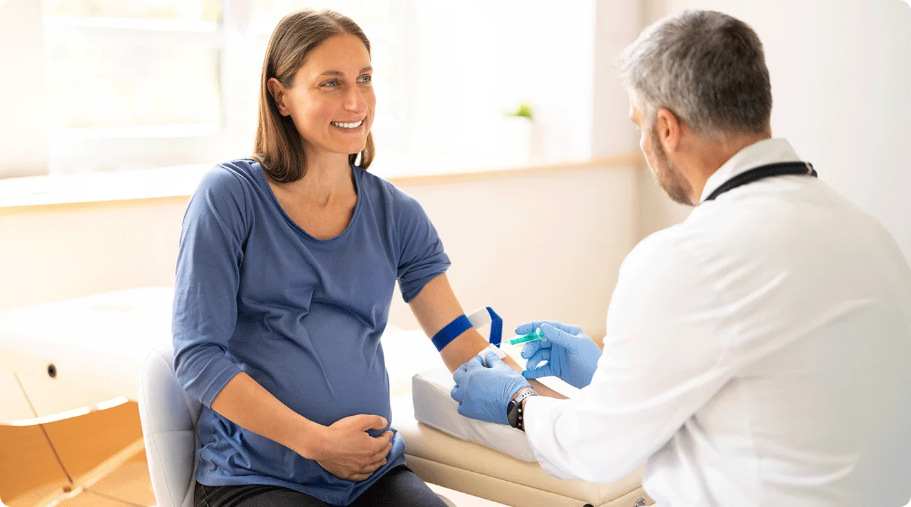 pregnant woman getting blood drawn by doctor