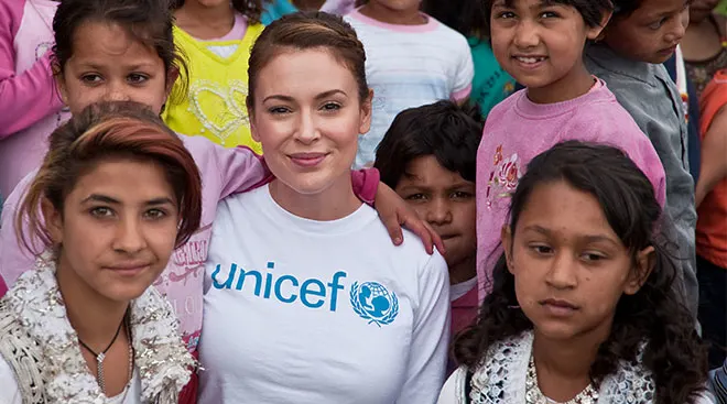 Celebrity Alyssa Milano pictured with children during UNICEF volunteer trip to Kosovo.