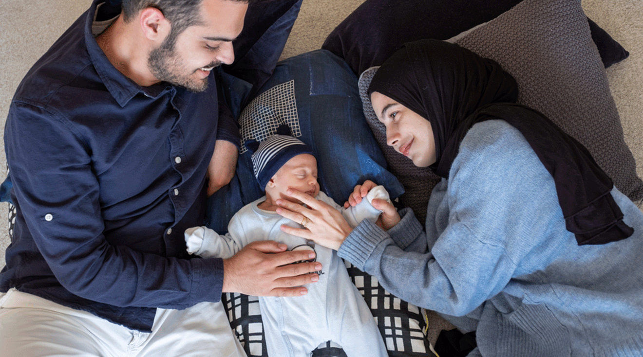 couple at home with newborn baby