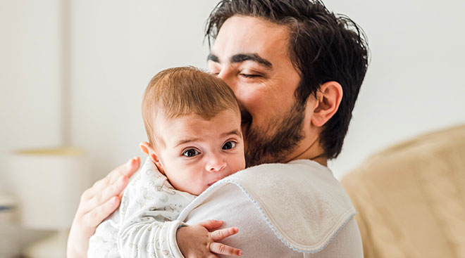 happy dad hugging his baby