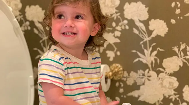 toddler girl learning during potty training lessons