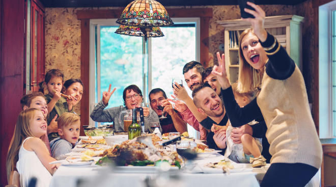 happy family taking a selfie during holiday dinner
