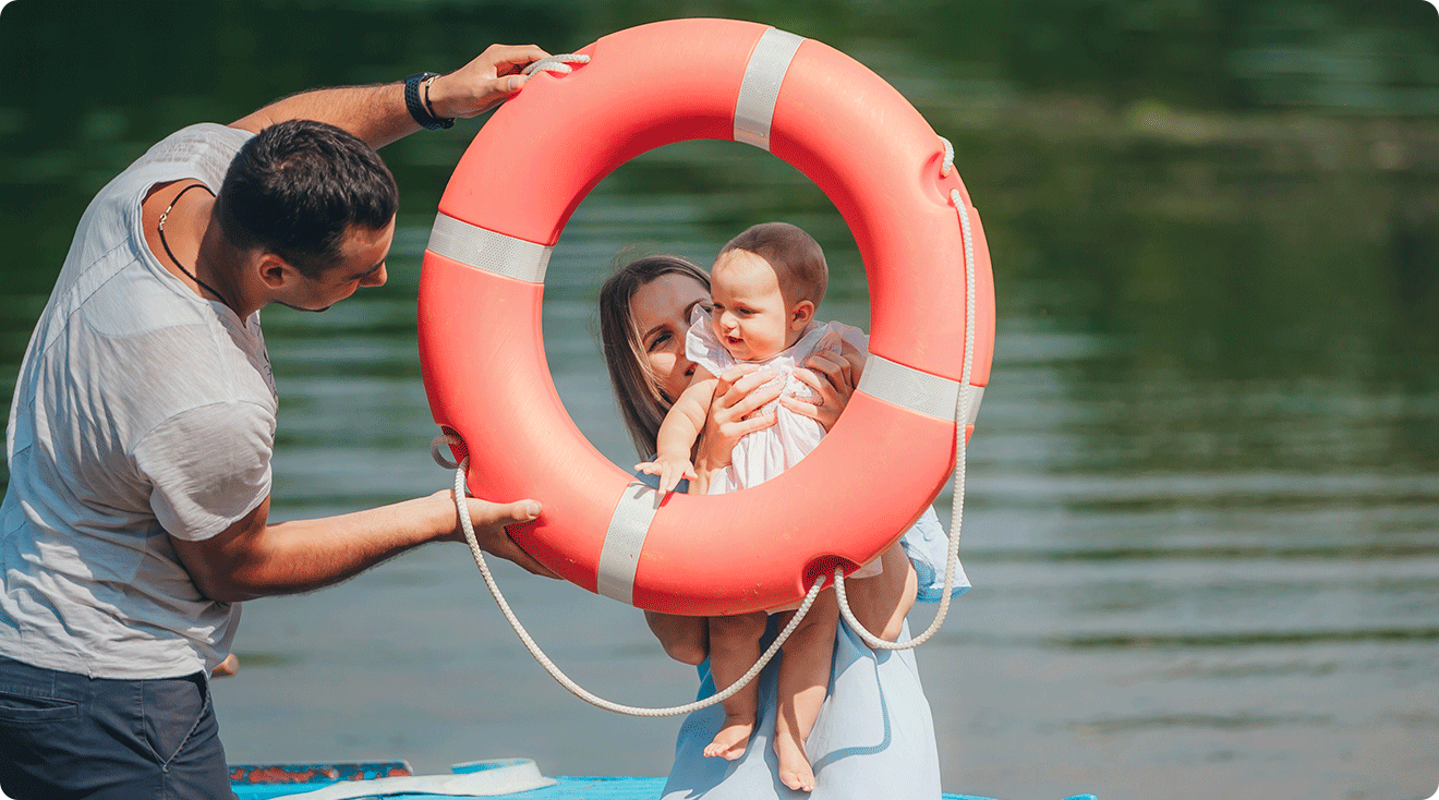 mom and dad having fun with baby during summertime