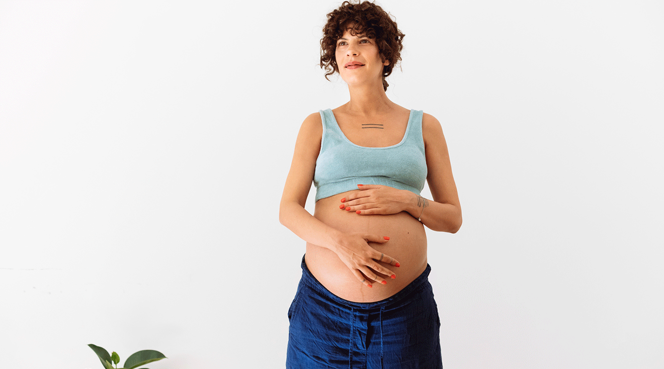 optimistic pregnant woman at home