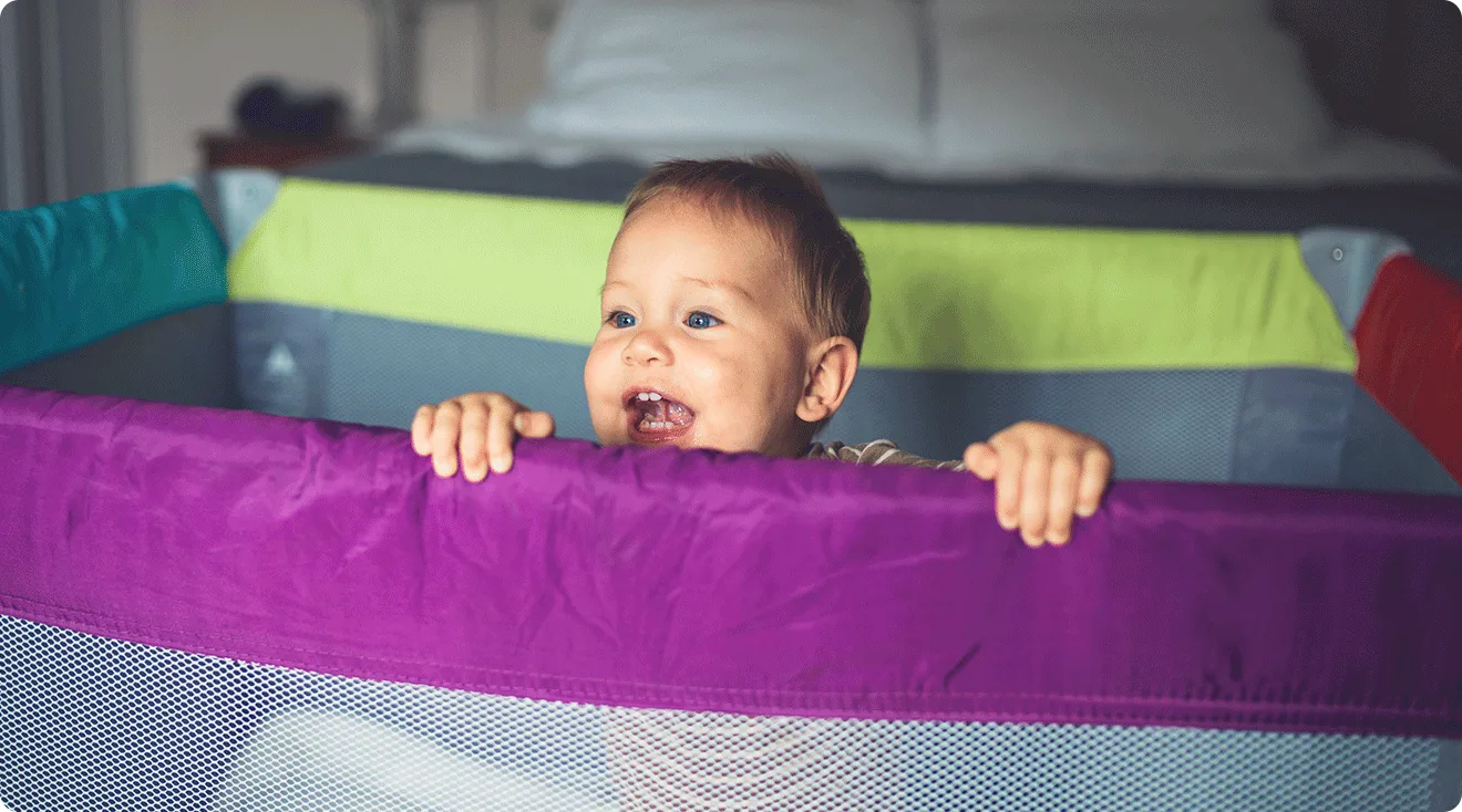 baby smiling in playard play pen