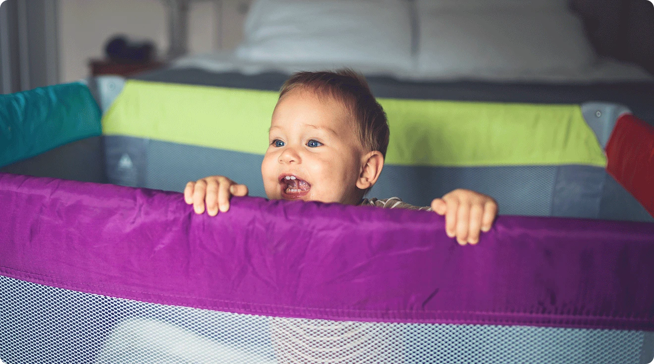 baby smiling in playard play pen