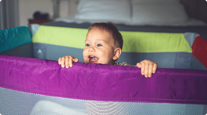 baby smiling in playard play pen