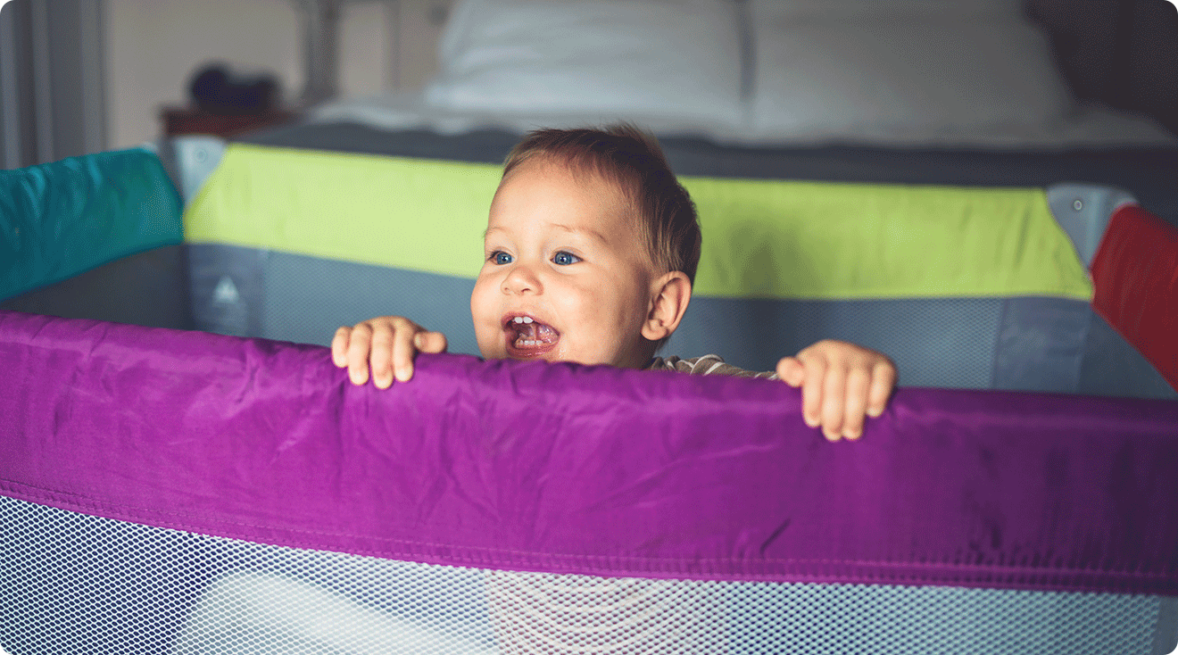 baby smiling in playard play pen