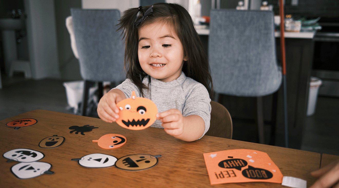 toddler doing halloween arts and crafts at home