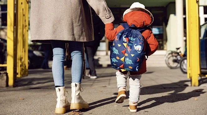 mother walking son into pre-k