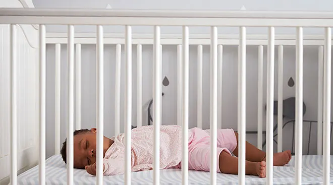 Baby sleeping safely in crib.