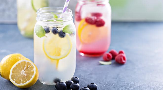 water in mason jars infused with fruit like lemon and raspberries