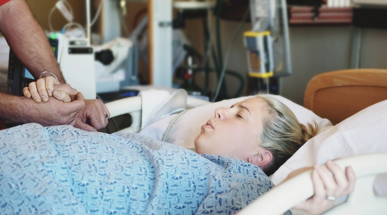 woman in labor in hospital bed