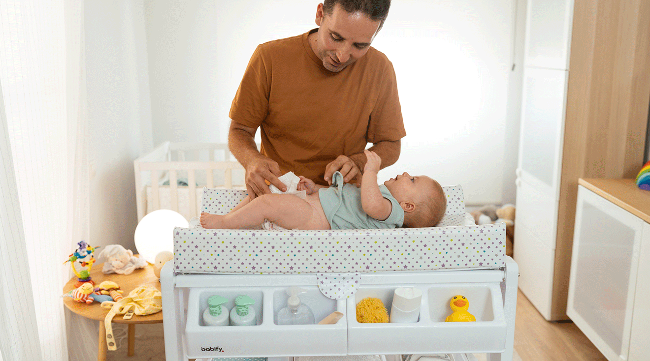 dad changing baby's diaper