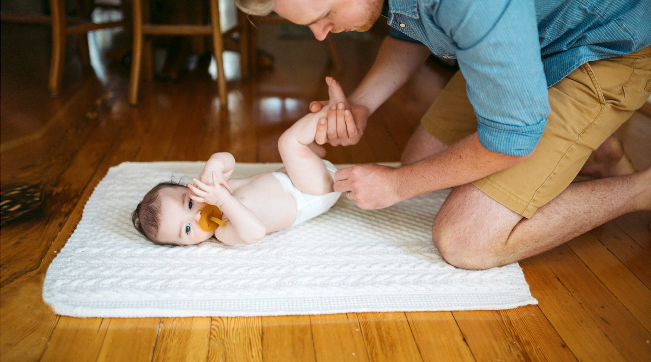 dad checking baby diaper