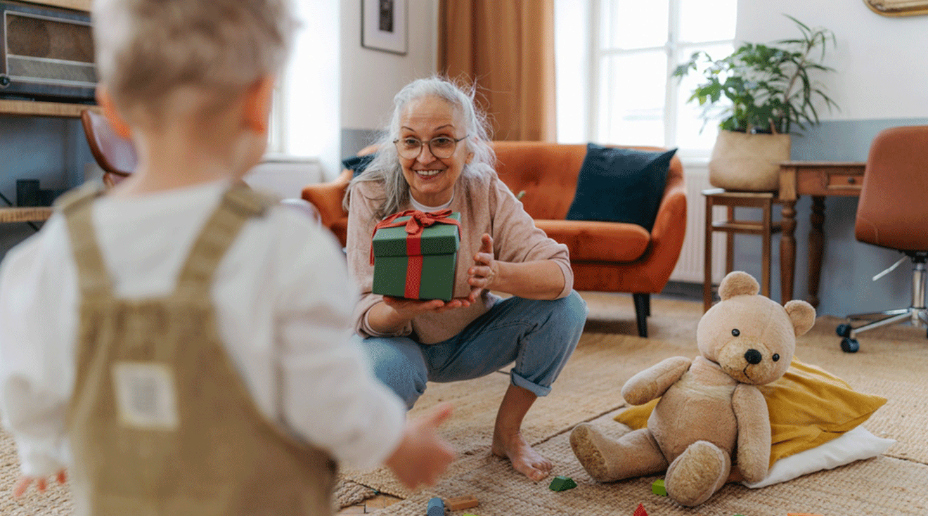 grandmother giving gift to toddler