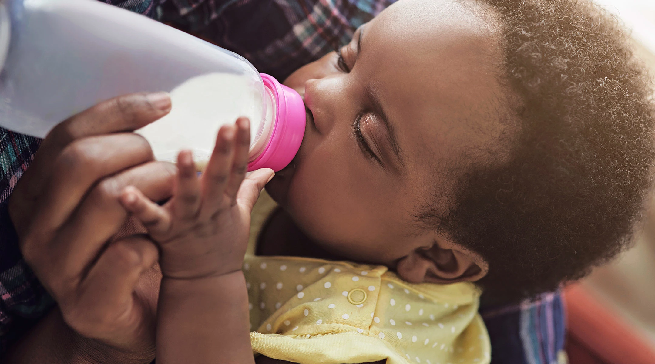 mom feeding her baby formula