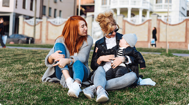 adult sisters with baby hanging out in the park