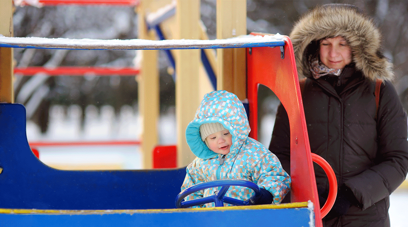 mom and toddler at playground during winter