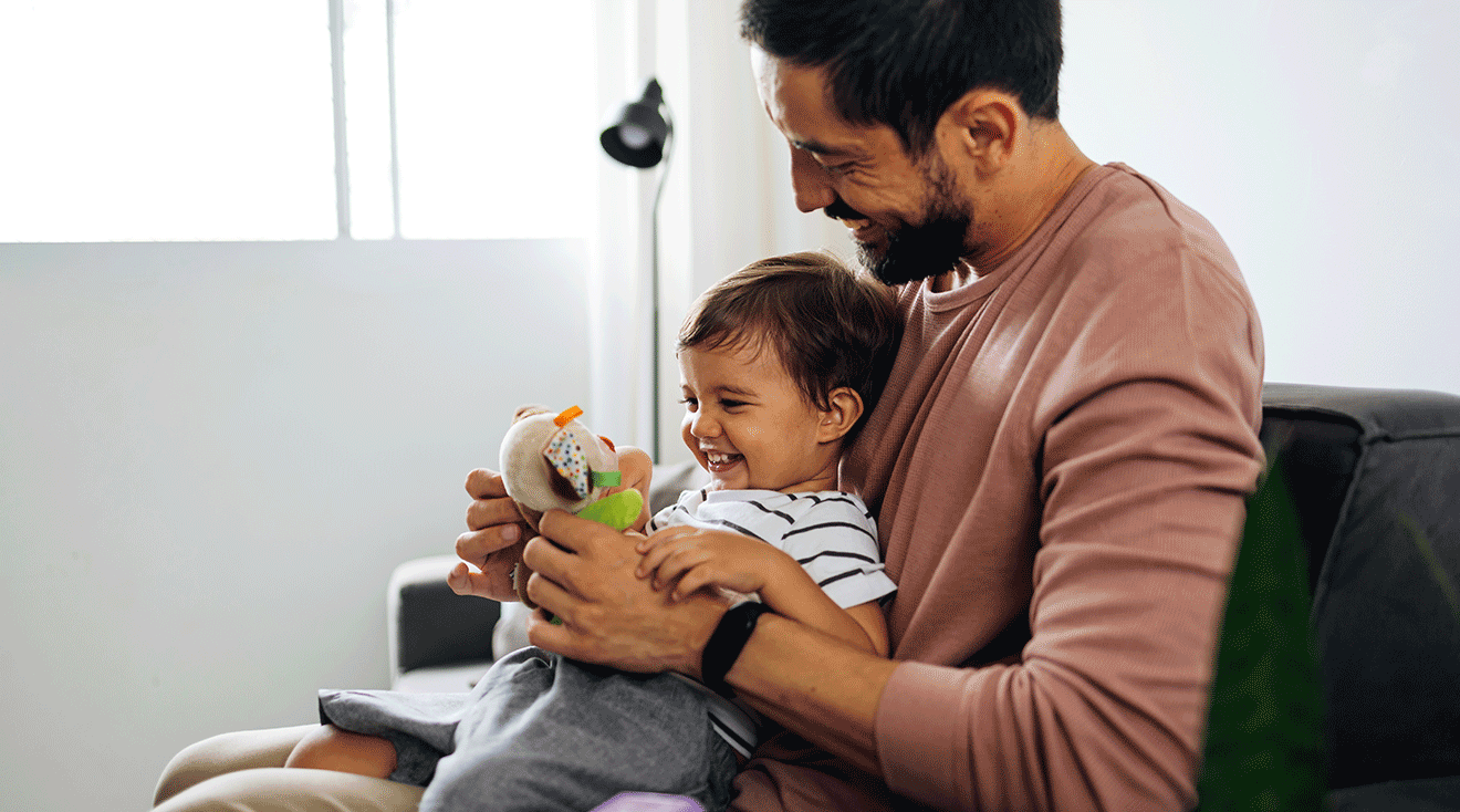 father and baby playing with toys