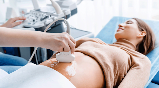 pregnant woman in first trimester getting an ultrasound
