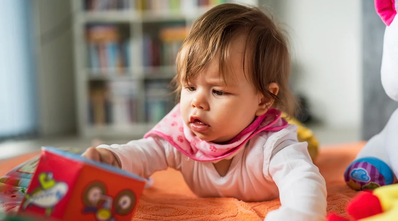 5 month old baby playing with toy at home