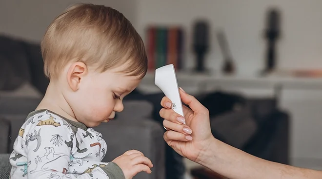 mother taking toddler's temperature