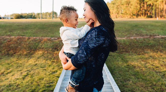 mom holding and embracing her one year old son