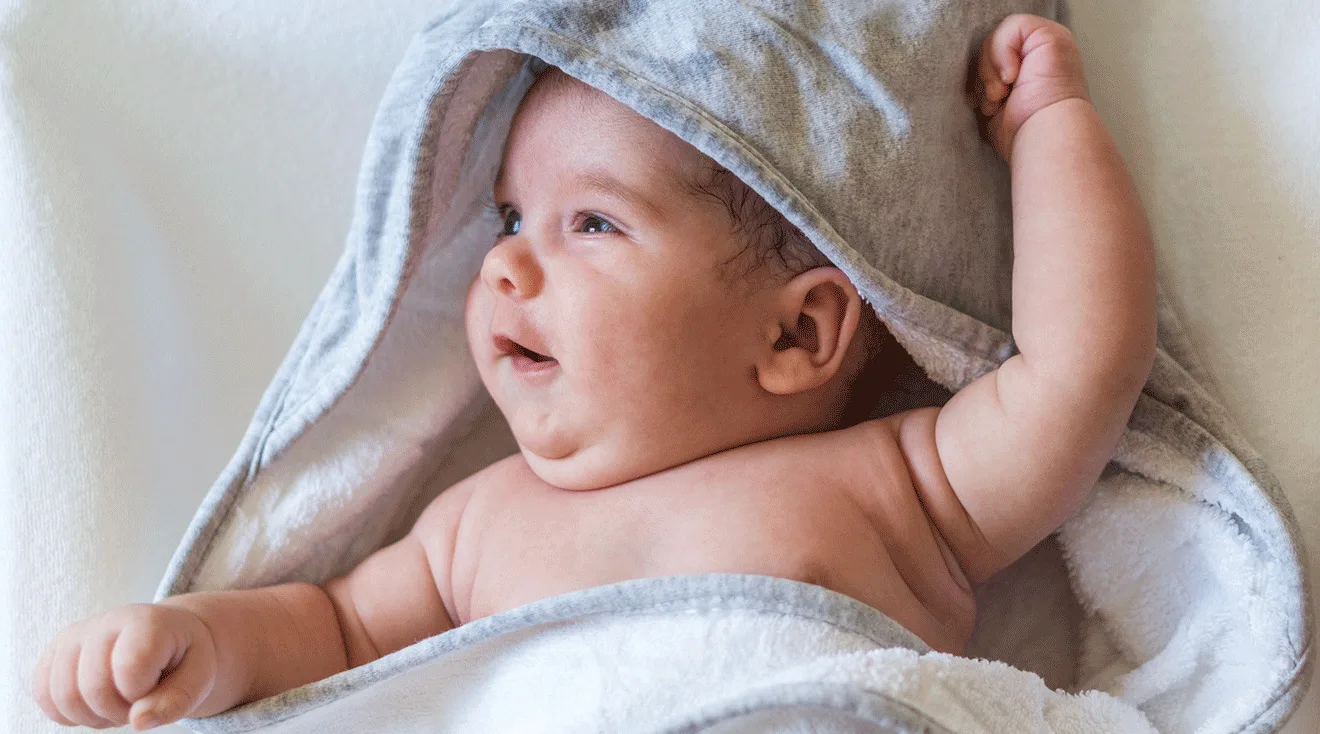 baby wrapped in towel after bath