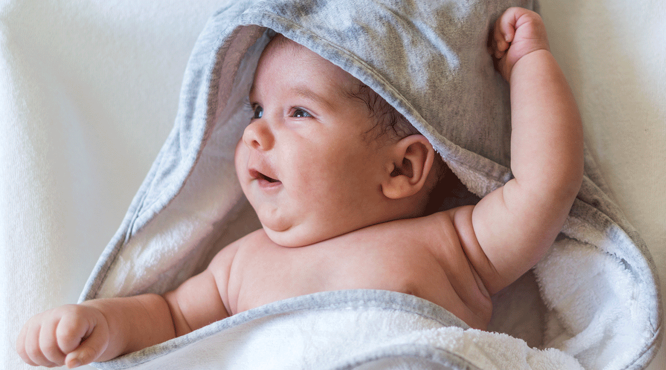 baby wrapped in towel after bath