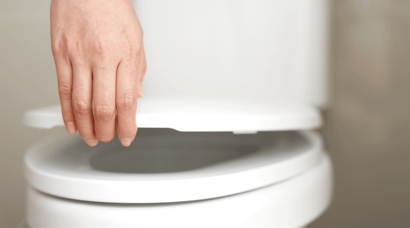 woman opening toilet lid