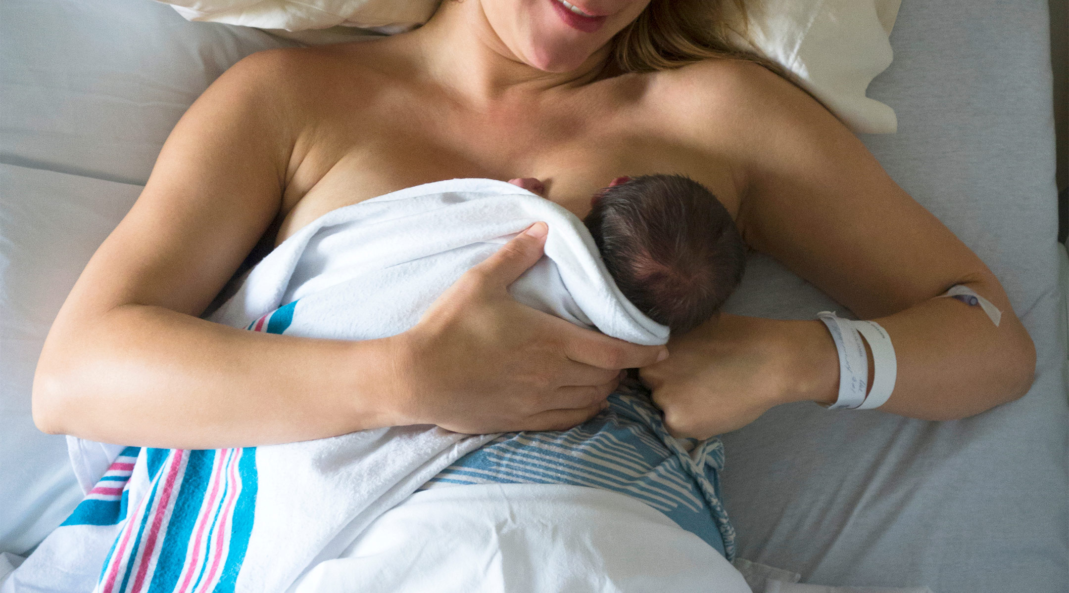 mom breastfeeding newborn baby after delivery in the hospital 