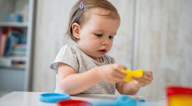 toddler playing with play doh