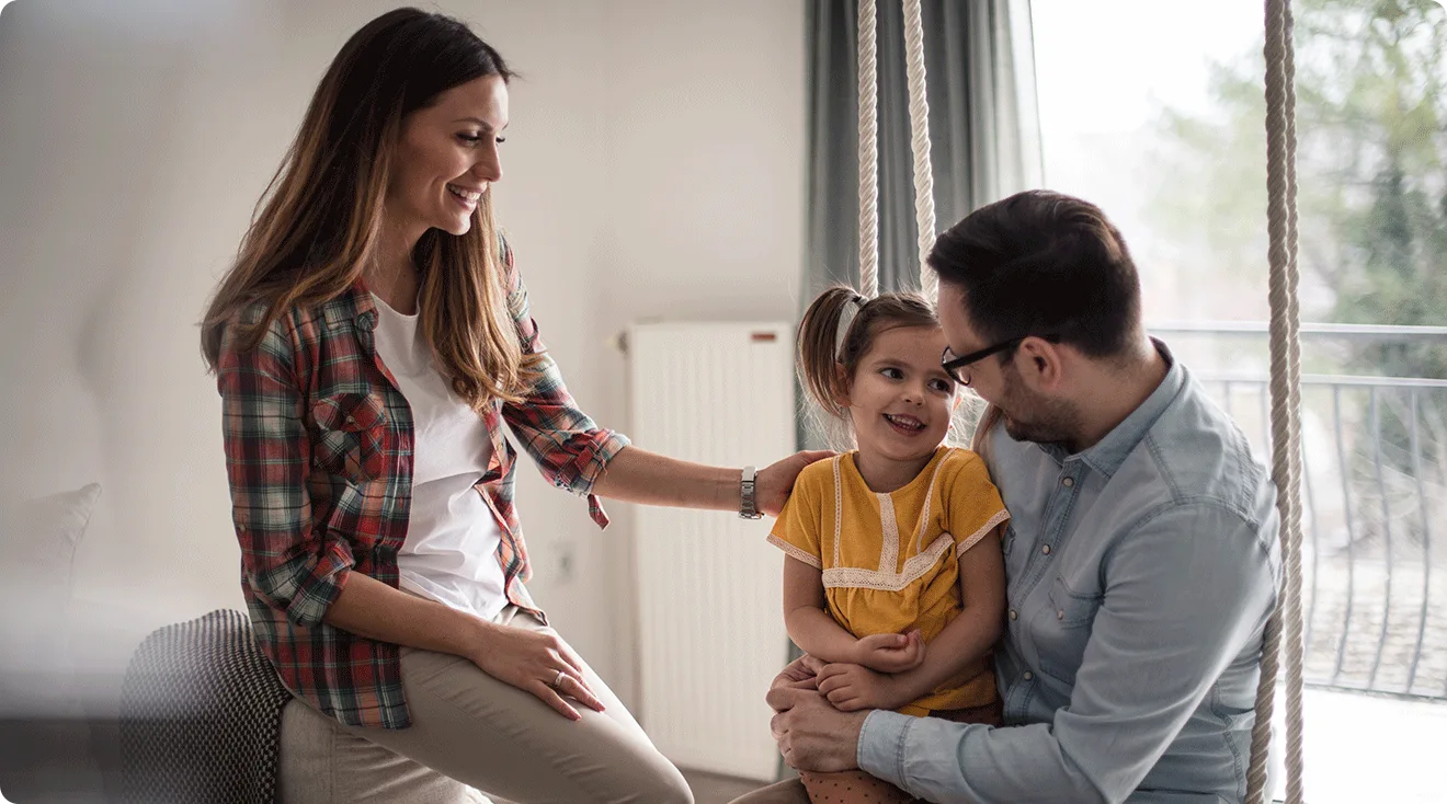 baby holding mom and dad's hand