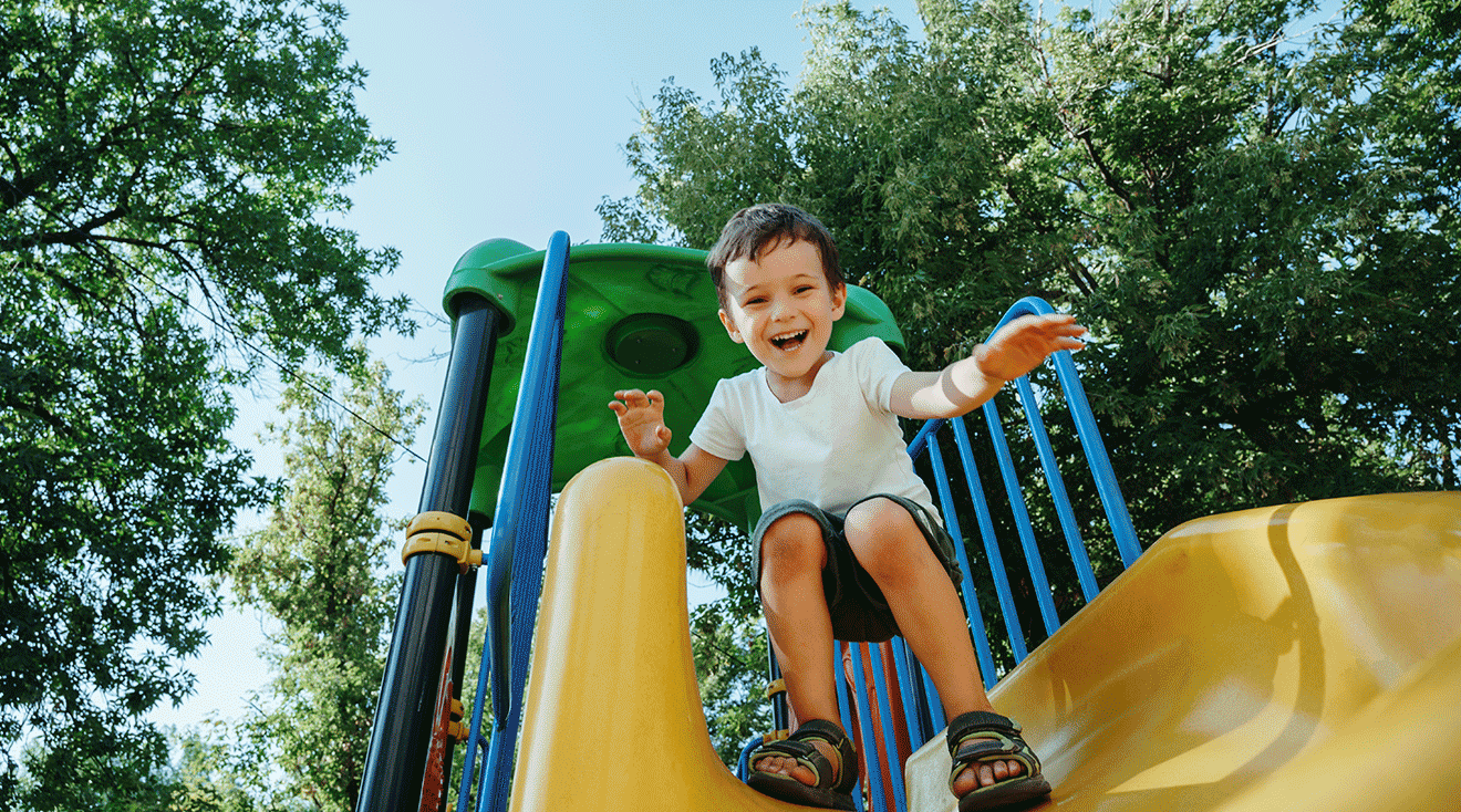 toddler boy playing on playground
