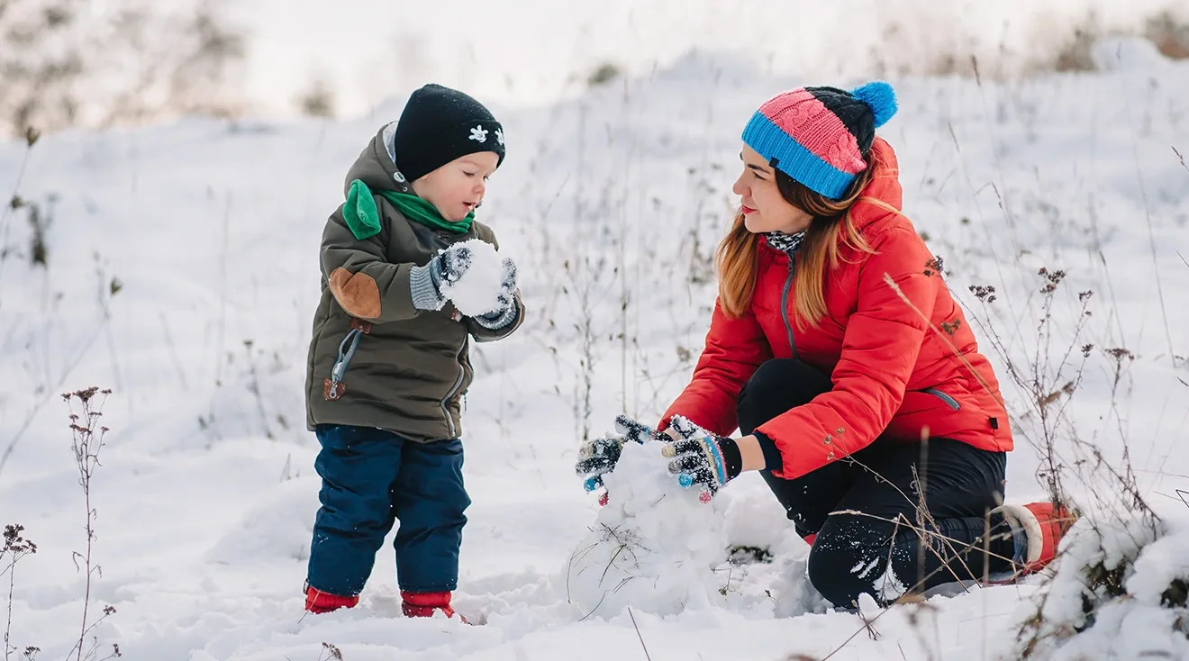 toddler playing in the snow