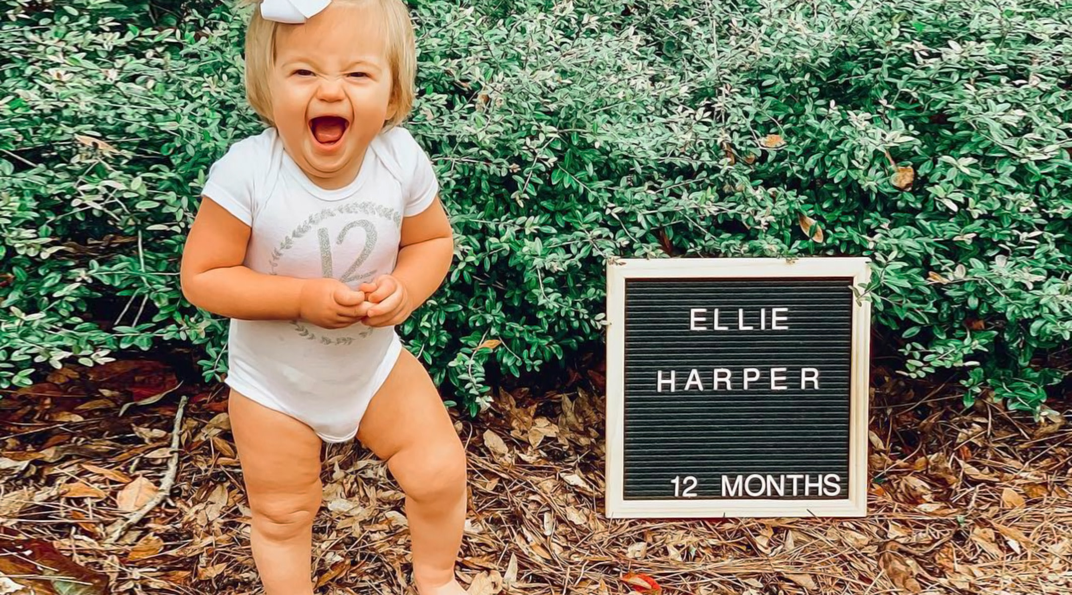 first birthday excited baby pictured with letterboard