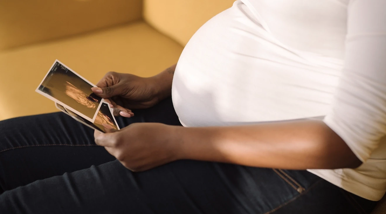 pregnant woman looking at ultrasound pictures