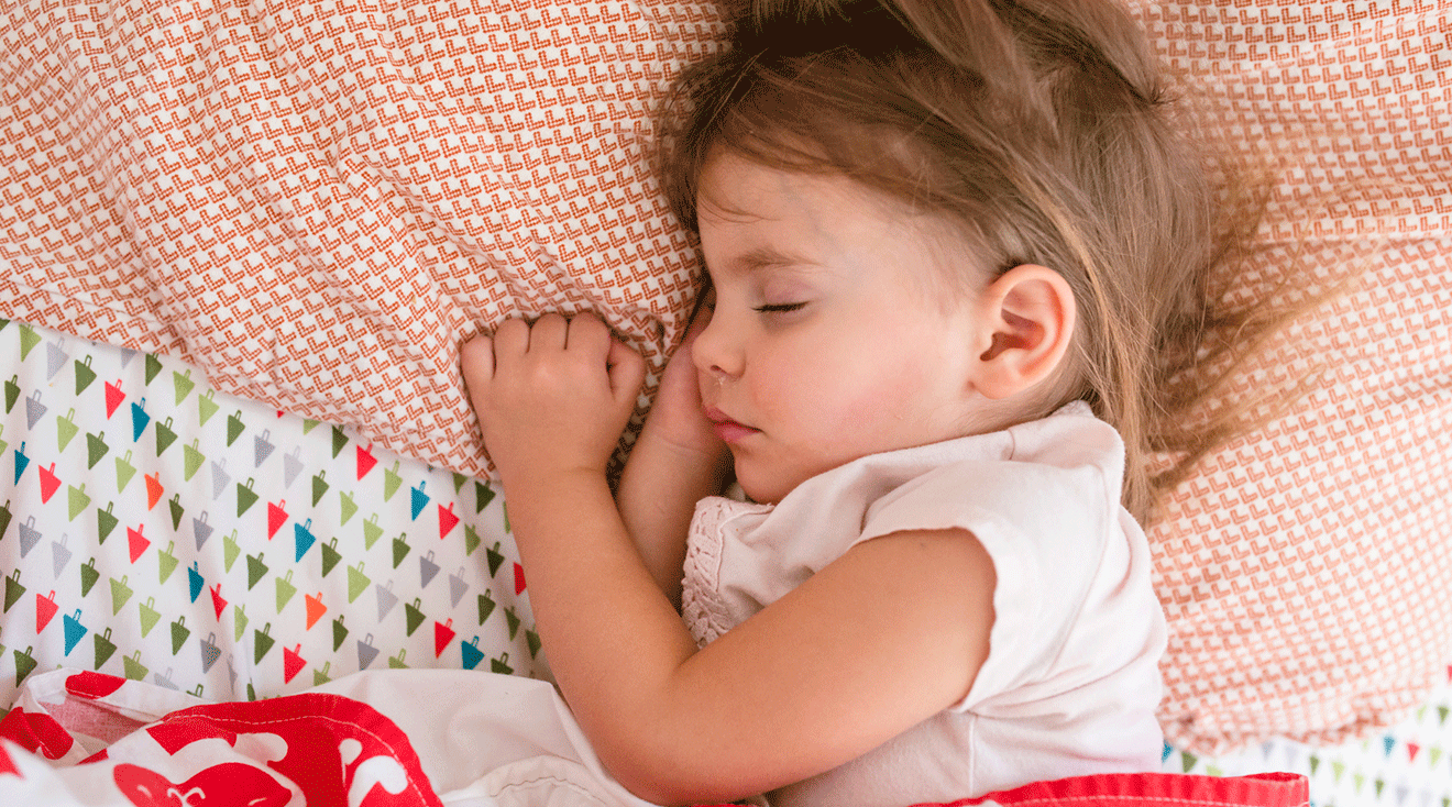 toddler girl sleeping in bed