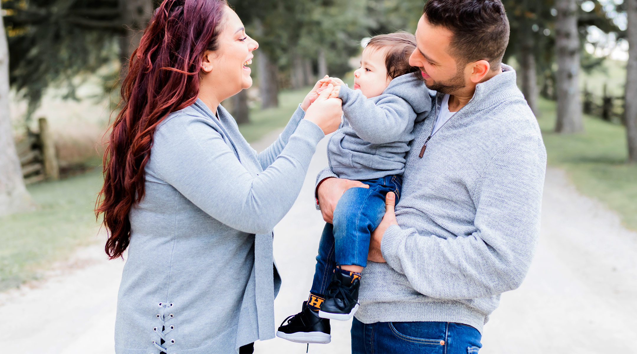 parents holding and talking with their baby