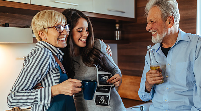 Getty Images family looking at sonogram picture together
